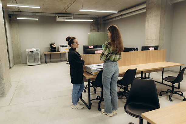 istock Two Businesswomen Engaged in Discussion in a Modern Open Workspace 2244269374