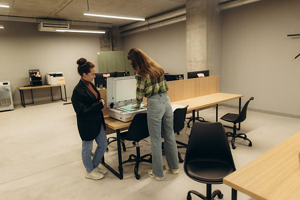 istock Two Women Collaborating at an Office Scanner Station in a Modern Workspace 2244269385