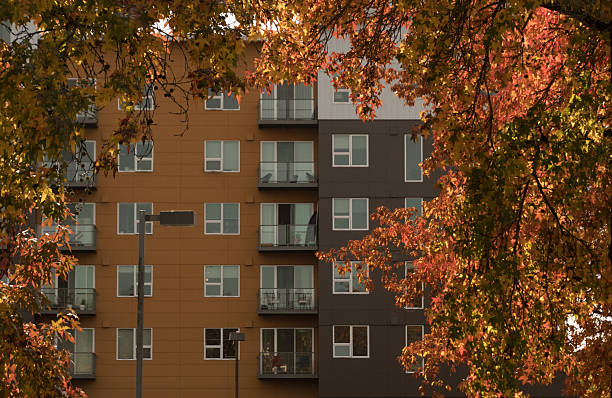 Bright fall leaves frame the facade of a contemporary apartment building in Redmond, Washington. A vibrant urban scene that highlights color, architecture, and Pacific Northwest lifestyle.