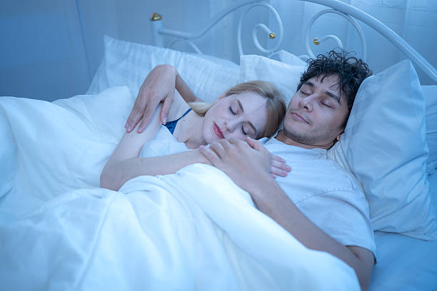 istock Loving couple cuddling peacefully in bed at night, showing warmth, affection 2244270291