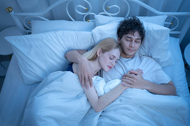 istock Loving couple cuddling peacefully in bed at night, showing warmth, affection 2244270303