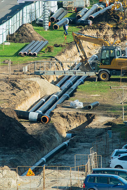 istock Construction site with underground pipeline installation and excavator 2244273291