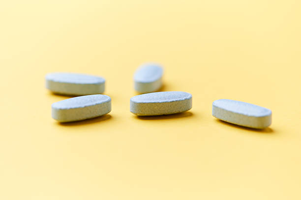 istock Multivitamin tablets on bright paper background. Close up. Copy space. 2244274214
