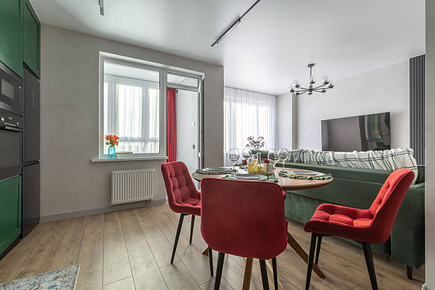 istock Modern Living Room and Kitchen with Red Chairs and Green Sofa 2244274547