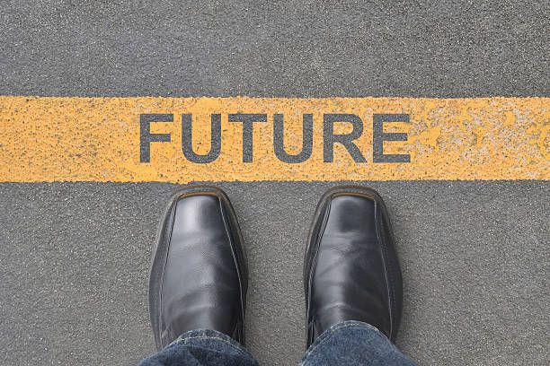 istock person standing at line with word future on asphalt road 2244275339