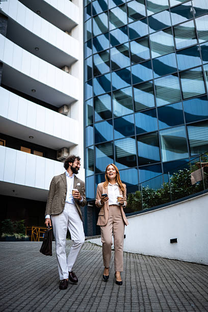 istock Businesspeople walking and talking outside office building 2244277244