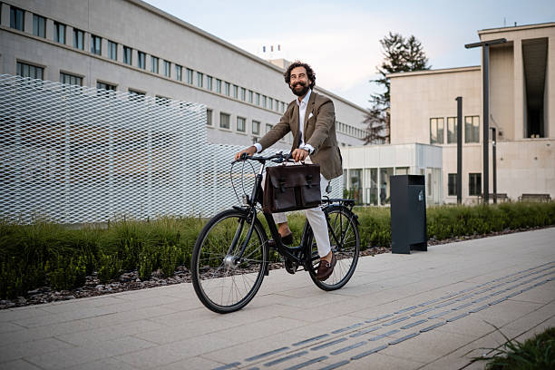 istock Businessman riding bicycle in urban environment 2244278536