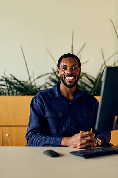 istock African American Man At Desk Smiling In Modern Office With Computer And Keyboard 2244280286
