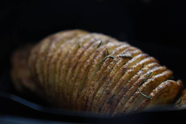 istock Crispy baked potato slices garnished with fresh rosemary 2244285012