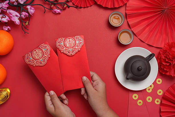 istock Chinese New Year celebration with red envelopes and tea 2244290780