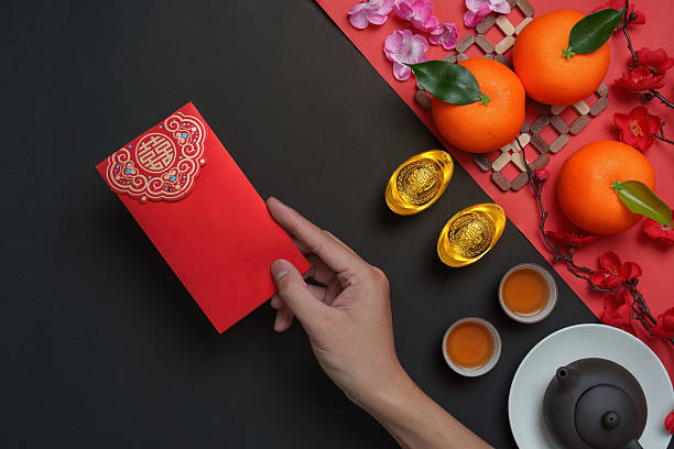 istock Chinese New Year red envelope with tea and oranges 2244290906