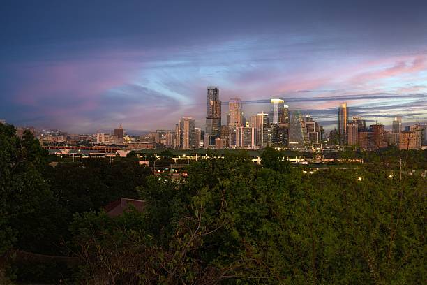 istock City skyline at dusk with colorful sky and trees. 2244291097