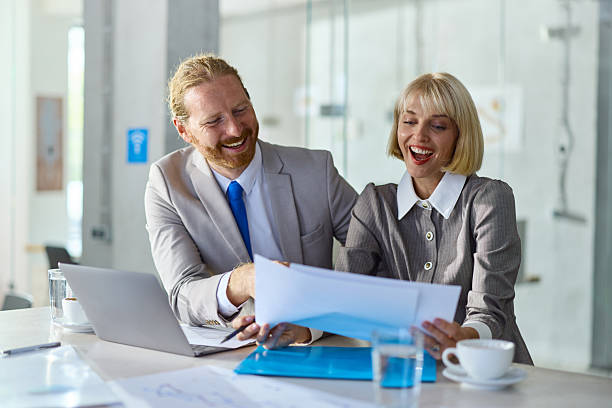 istock Happy entrepreneurs analyzing paperwork in the office. 2244291569