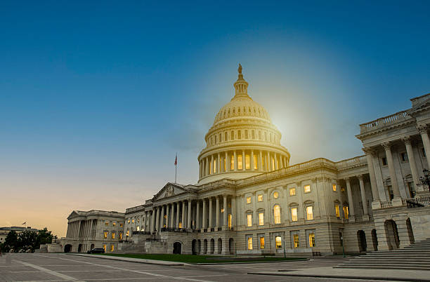istock Capitol building washington dc with bright light in night sky 2244293659