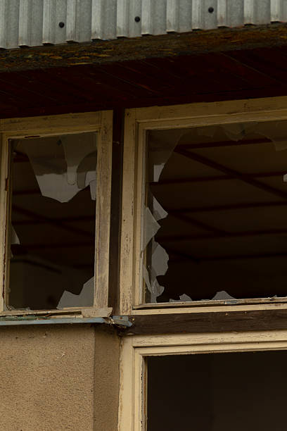 istock There is a broken window located on the side of a tall building 2244294726