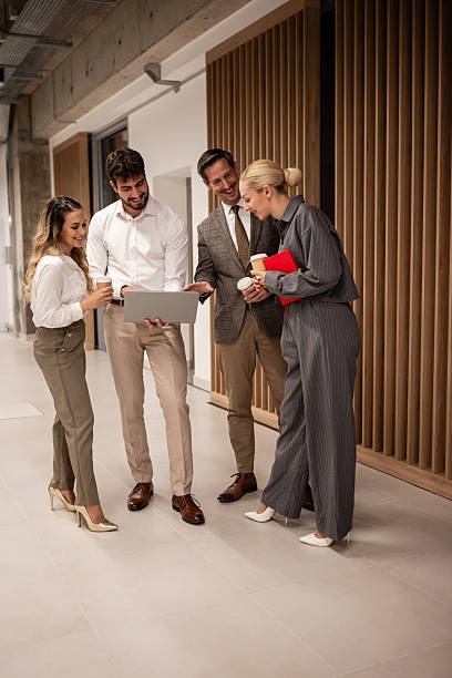 istock Business colleagues collaborating on laptop in office hallway 2244297360