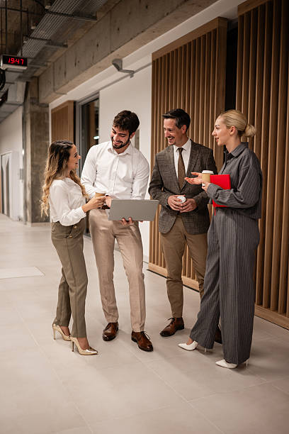 istock Business colleagues collaborating on laptop in office hallway 2244297509