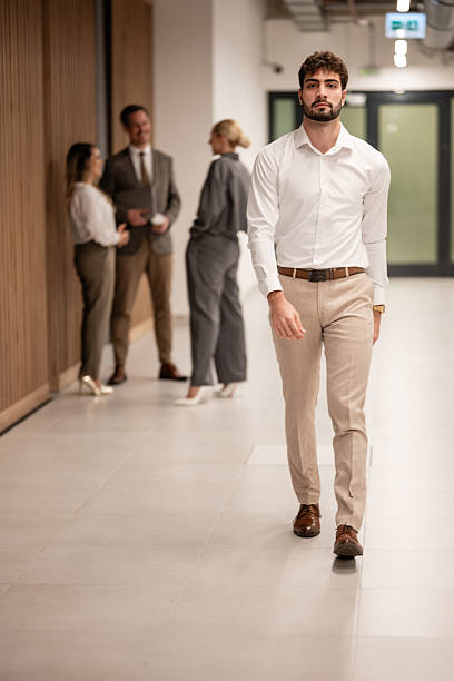 istock Confident business man walking in office hallway 2244299261
