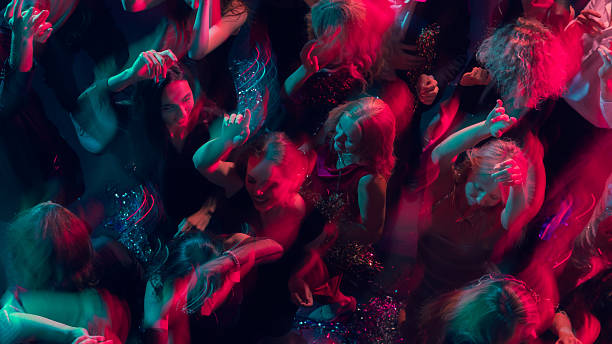 istock Festive night dance with motion blur and glowing pink-blue light 2244300064