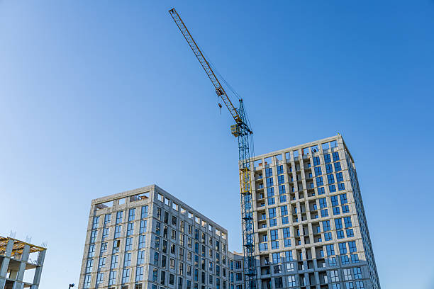 istock A construction site features two residential buildings nearing completion, with a crane working overhead on a sunny day 2244303516