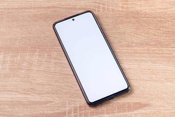 istock A smartphone with blank white screen on the wooden table 2244305811