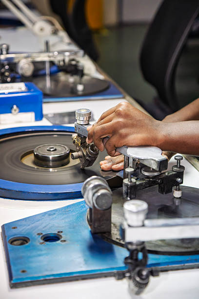 istock african workers, diamond polisher at work, using a polishing wheel to shape and refine a rough diamond, brillianteering 2244306879