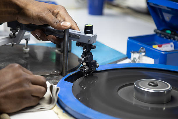 istock african workers, diamond polisher at work, using a polishing wheel to shape and refine a rough diamond, brillianteering 2244307123