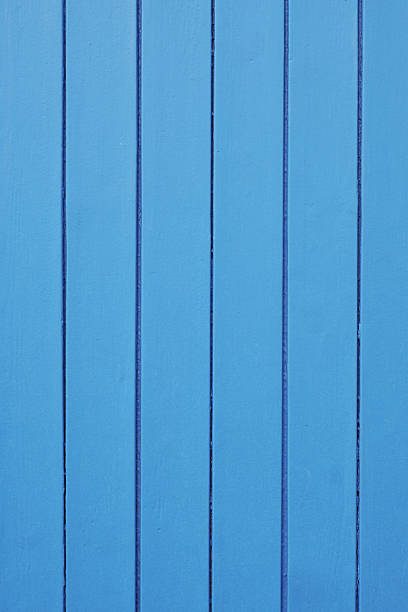 wood background with vertical panels and blue paint