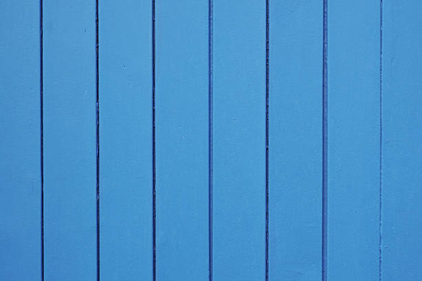 wood background with vertical panels and blue paint