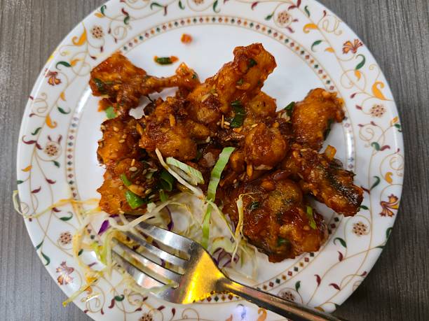 istock Plate of Crispy Fried Cauliflower Manchurian Garnished with Spring Onion and Cabbage 2244312190