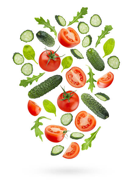 istock Bright vegetable salad ingredients - red tomato, green cucumbers, greens -  fly or fall as flow art composition, isolated. Wholesome, vitamin ingredient for antioxidant salads, healthy dietary menus. 2244313855