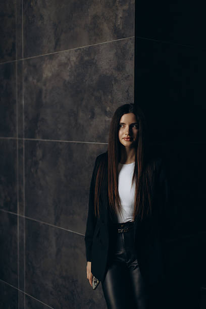 istock Businesswoman Posing Confidently in a Dark Modern Interior Setting 2244315223