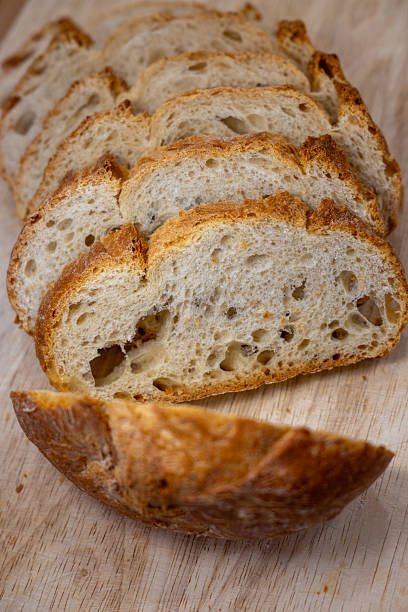 istock Freshly baked sliced artisan bread on wood 2244318944