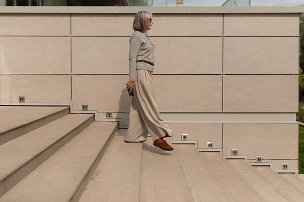istock Woman walking down outdoor stairs in a modern setting during daylight 2244319527
