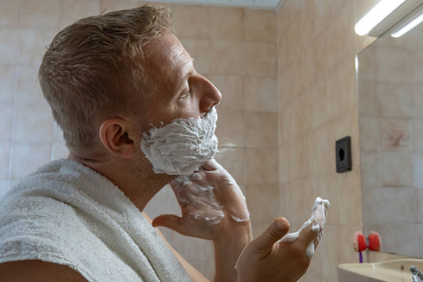 istock Man applying shaving foam in bathroom 2244320374