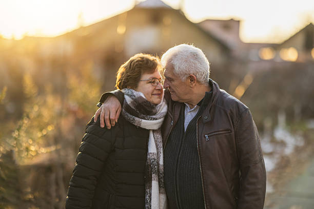 istock Senior Couple Embracing at Sunset 2244322114