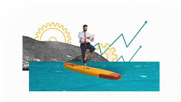 Digital composition. Businessman practicing balance on paddleboard with tablet over sea and growth chart