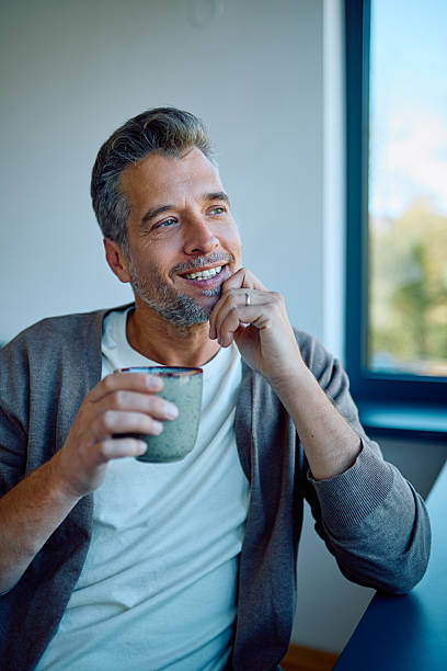 istock Happy man relaxing, enjoying morning coffee or tea 2244323631