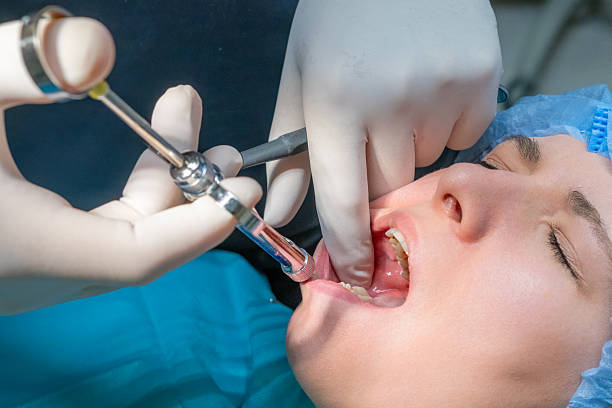 istock Dentist administers local anesthetic injection into patient gums. 2244323934