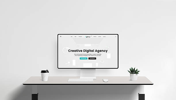 istock White computer monitor with creative digital agency interface on clean desk, minimal office setup with coffee cup and green plant decor 2244325673