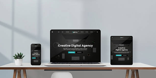 istock Laptop, tablet, and smartphone on minimalist desk display creative digital agency responsive website interface in dark mode, modern workspace with natural light 2244325684