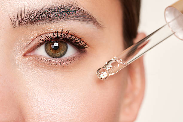 istock Young beautiful woman applying face serum 2244326811