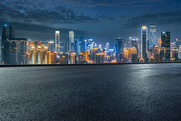 istock Empty asphalt road and modern city skyline at night. 2244326881