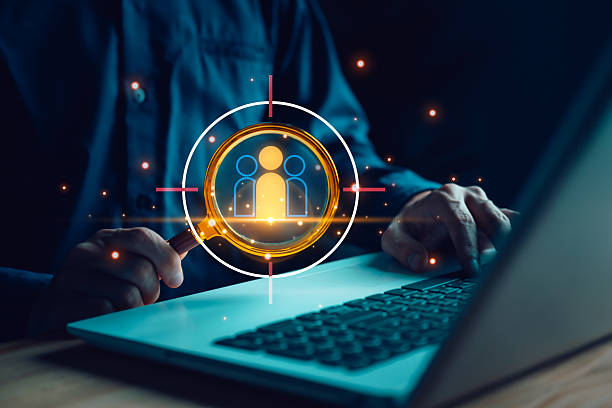 istock Recruiter using magnifying glass targeting best candidates on laptop, symbolizing HR analytics, talent acquisition, employee search, or workforce optimization in digital recruitment. 2244328401
