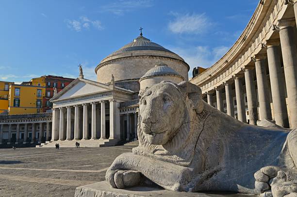 An exterior view of an impressive Basilica, lined with columns in the Italian city of Naples
