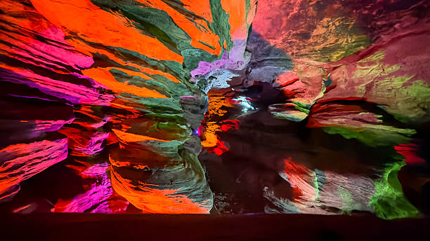 istock Vibrantly Lit Cave with Reflections of Multicolored Lights on Stone Walls 2244330958