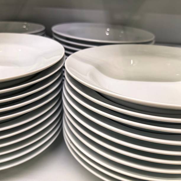 istock Dishes, plates, dishes on the shelf, white plates, dishes washed, plates in the cupboard, cupboard for plates, wash the dishes, put them away neatly, neat at home, cleaning, after eating 2244332003