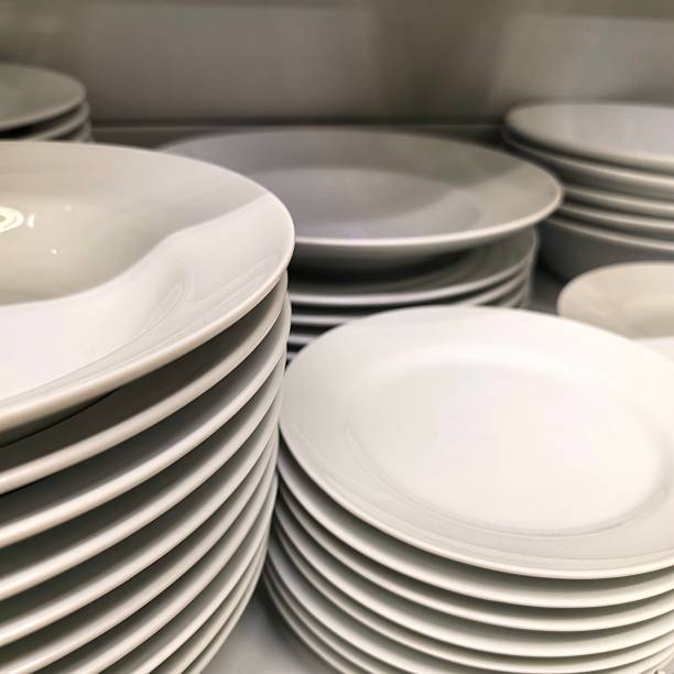 istock Dishes, plates, dishes on the shelf, white plates, dishes washed, plates in the cupboard, cupboard for plates, wash the dishes, put them away neatly, neat at home, cleaning, after eating 2244332007