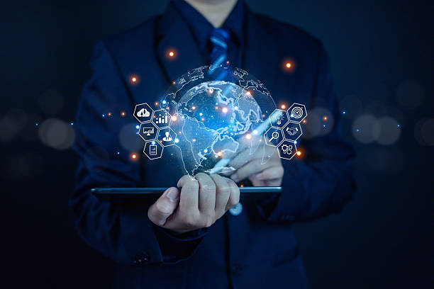 istock Businessman using digital tablet with virtual globe and network icons, representing global business technology, data analytics, and innovation for worldwide connection and digital transformation. 2244333619