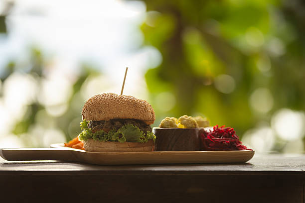 Hamburger is serving with pickles and vegetables.